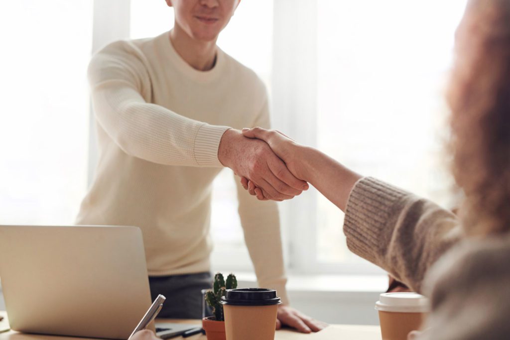 man shaking hand in interview